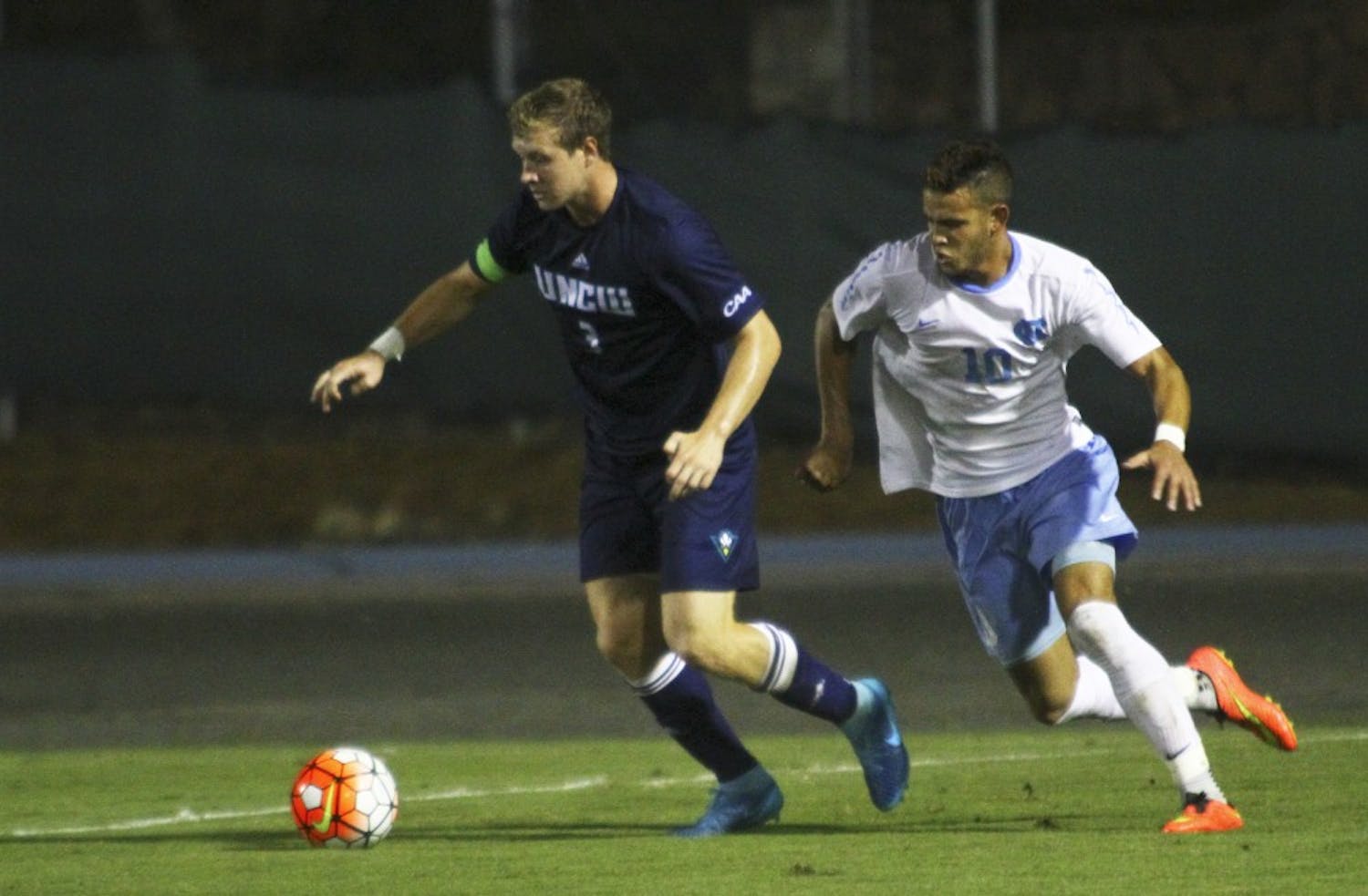 Sophomore Zach Wright (10), forward, fights a defender for possession. Wright scored two of three UNC goals Tuesday night in a win over UNC-Wilmington. 