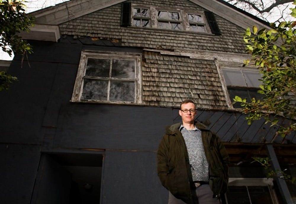 Ernest Dollar, executive director of the Preservation Society of Chapel Hill, stands outside the Graham House.