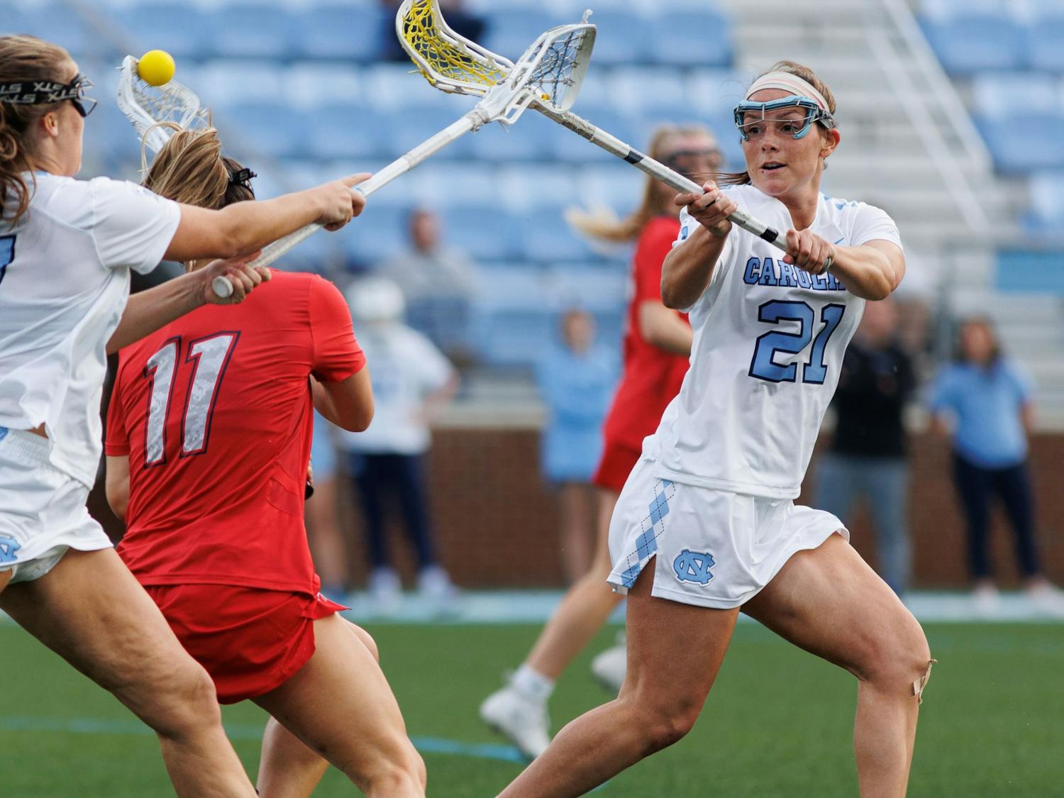 UNC first-year attacker Marissa White (21) fights for the ball during the women's lacrosse game against Liberty on Wednesday, Feb. 15, 2023, at Dorrance Field. UNC beat Liberty 18-6.
