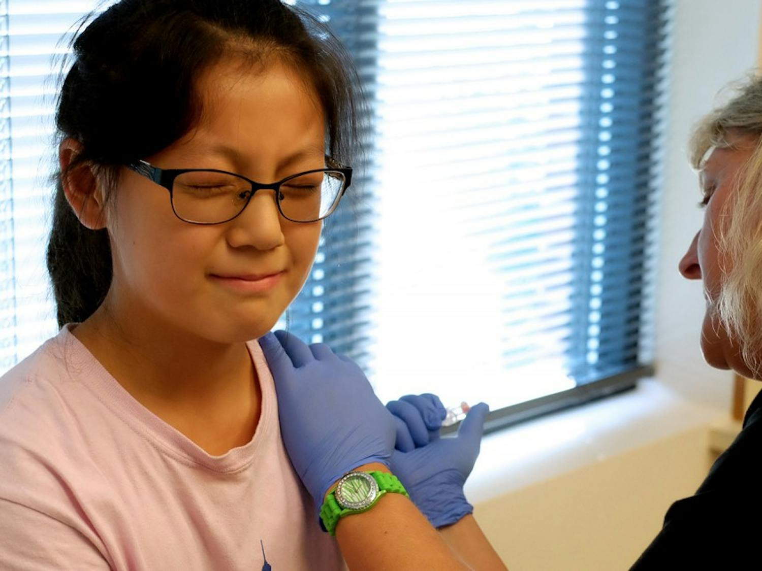 Melissa Du, 11, bravely sits still for the Tdap vaccine. The Tdap protects against tetanus, diphtheria, and pertussis. Not a single tear was shed. 
