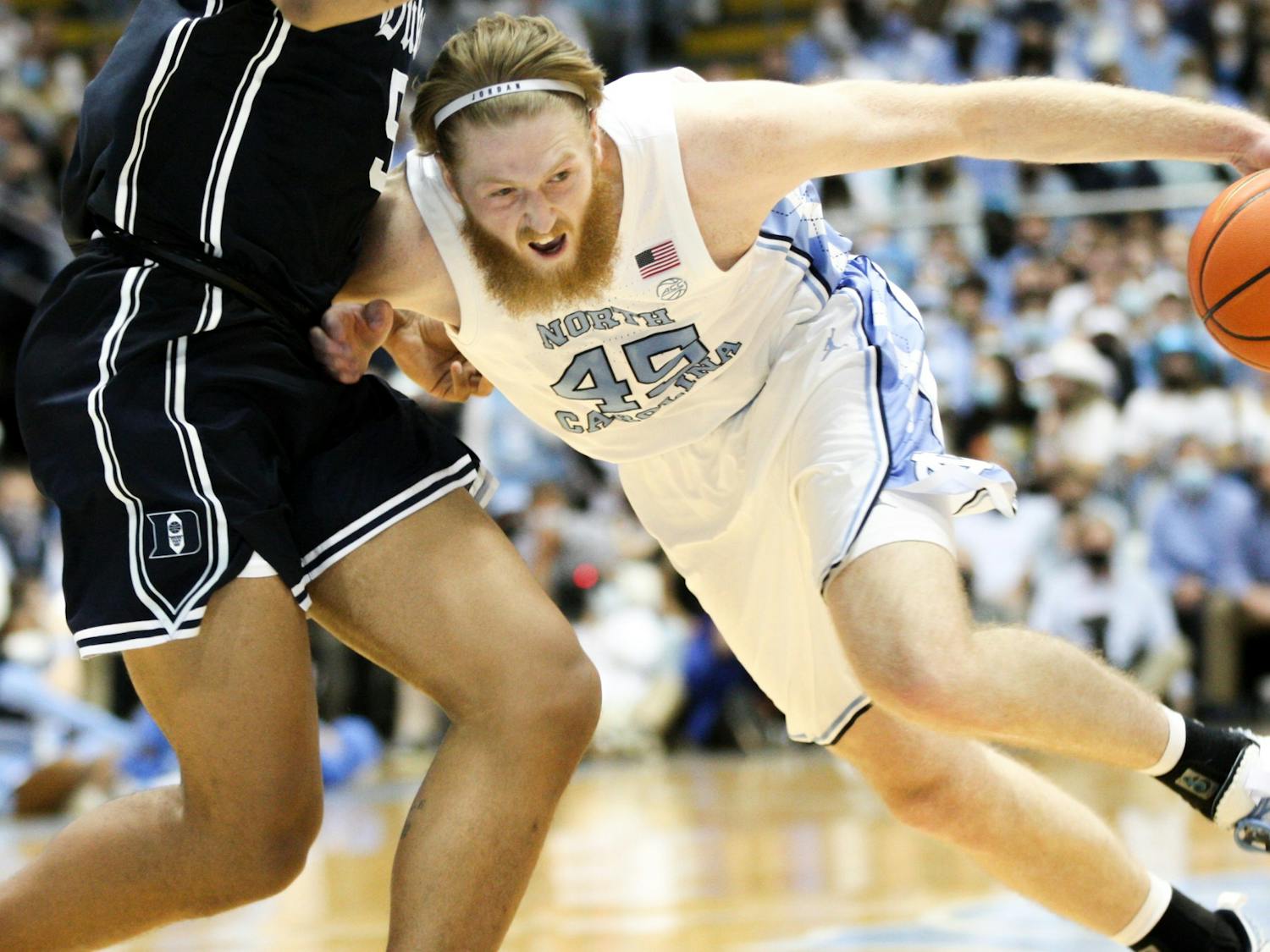 Graduate guard Brady Manek (45) drives the ball into the paint during UNC men's basketball home game against Duke in the Dean Smith Center on Saturday, Feb. 5, 2022.
