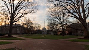 The sun rises behind Wilson Library on Friday, Feb. 24, 2023.