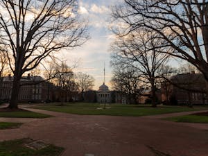 The sun rises behind Wilson Library on Friday, Feb. 24, 2023.