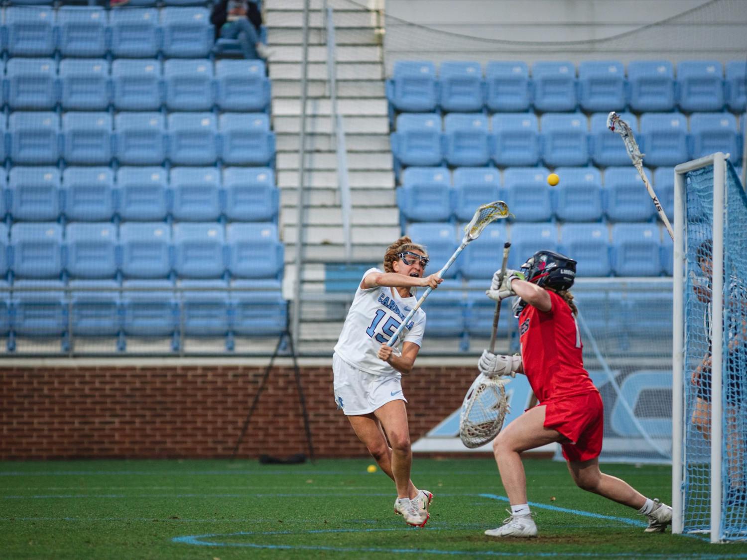 UNC junior attacker Caitlyn Wurzburger (15) scores during the women's lacrosse game against Liberty on Wednesday, Feb. 15, 2023, at Dorrance Field. UNC beat Liberty 18-6.