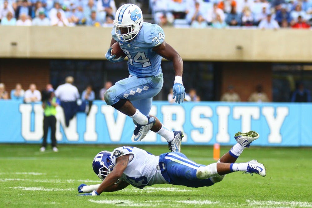 North Carolina sophomore Elijah Hood (34) jumps over a Duke player during the second half of Saturday's game.&nbsp;