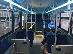 2 passengers with masks sit on a Chapel Hill Transit bus on the FG route. Photo Courtesy of Jeffrey Sullivan.