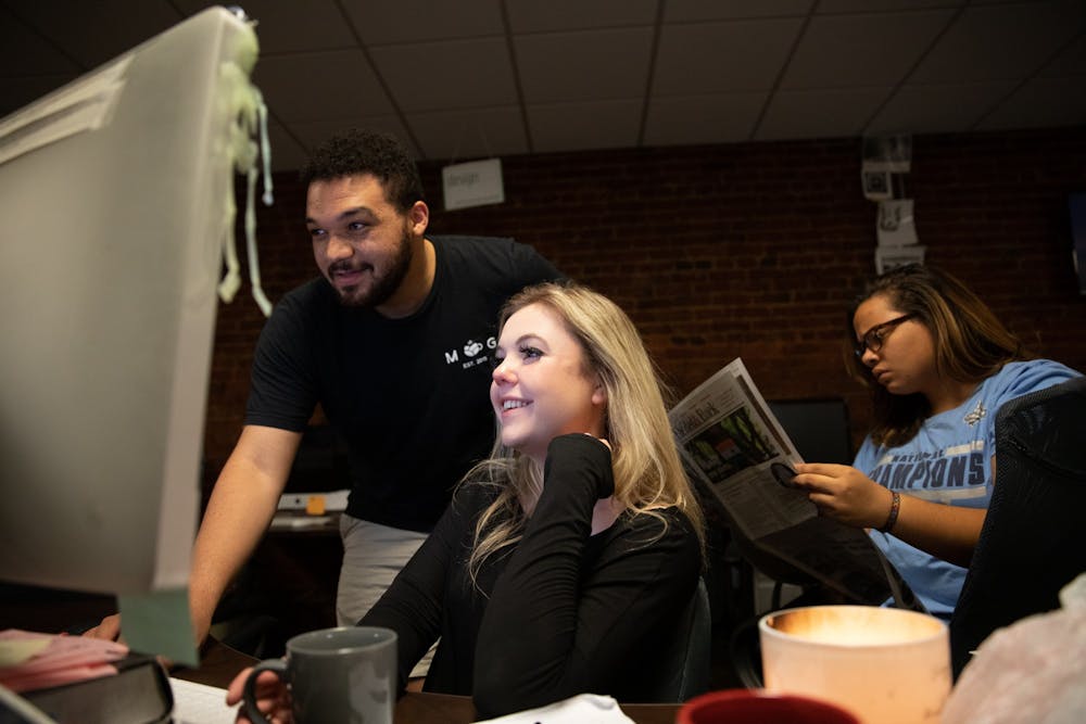 Former Copy Chief Brandon Standley and Editor-in-Chief Maddy Arrowood work on the paper in the DTH's office on Oct. 29, 2019.