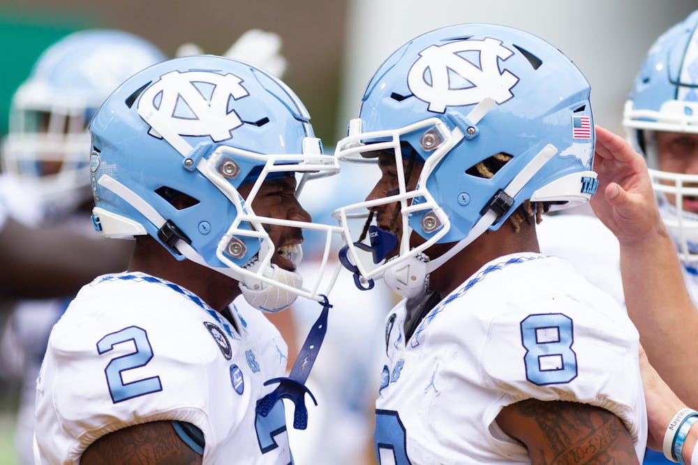 Redshirt freshman wide receiver Gavin Blackwell (2) and redshirt freshman wide receiver Kobe Paysour (8) celebrate after a scored UNC touchdown at the game versus Appalachian State at Kidd Brewer Stadium on Sept. 3, 2022. The Heels won 63-61.