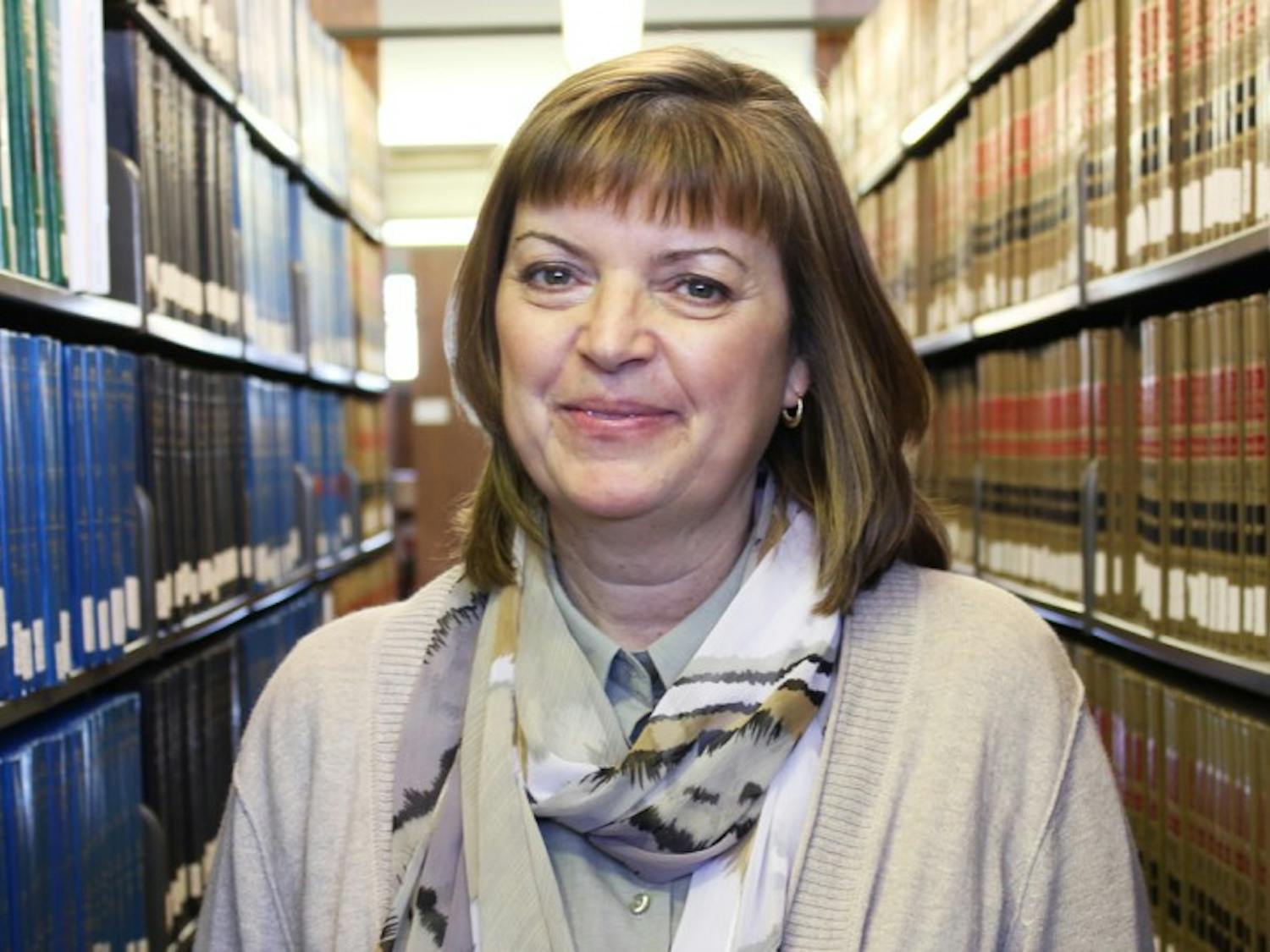 Martha Svoboda stands in the law library. 
