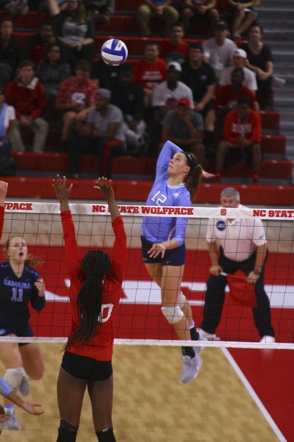 Julia Scoles (12) goes up for one of her many kills during the game against N.C. State. 