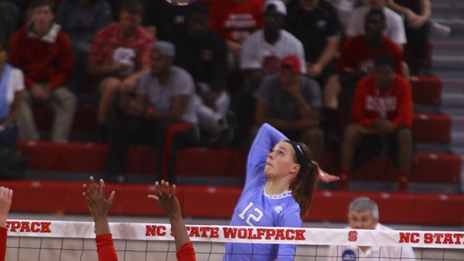 Julia Scoles (12) goes up for one of her many kills during the game against N.C. State. 