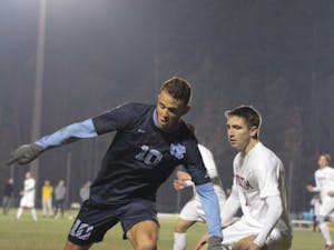 Forward Zach Wright (10) around a Fordham defender on Dec. 2 at WakeMed Soccer Park in Cary.
