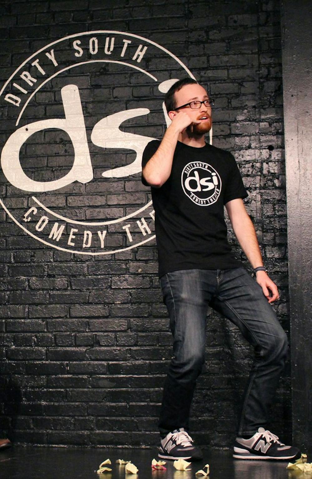 Slam, Inc. performed a show at DSI Comedy Theatre in Carrboro on Thursday night. Craig Carter, on the black team, plays an improv game  involving audience-contributed phrases while the red team looks on. (L to R: Meagen Voss, Bryce Bowden, Brad Taylor)