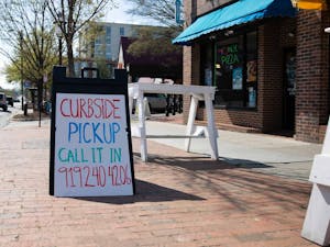 A sign advertising curbside pickup stands outside the Trolly Stop on Friday, March 20, 2020. &nbsp;All restaurants were forced to stop dining in services and are open only for pick up or deliveries to stop the spread of COVID-19. &nbsp;