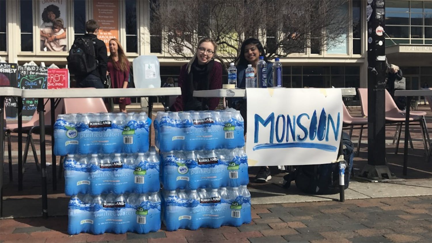 (From left) Juniors&nbsp;Allory Vors and Shilpa Kancharla collect water bottles on behalf of Monsoon to be sent to Flint, Mich., for relief.