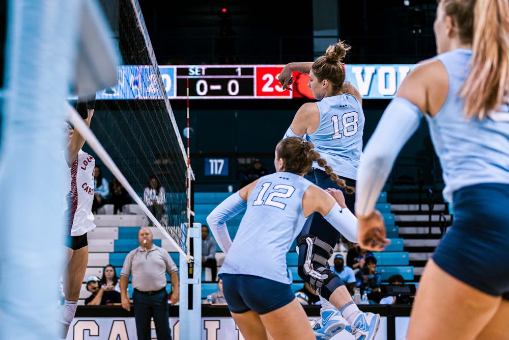 UNC first-year Liv Mogridge (18) wins a point off a hit in a close first set during the volleyball match against Louisville on Sunday, Nov. 13, 2022. UNC fell 3-0 to Louisville.