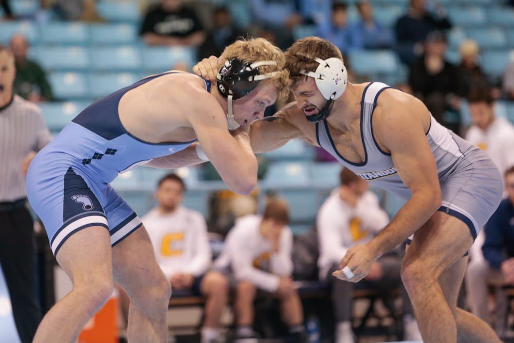 UNC redshirt sophomore wrestler Clay Lautt grapples with Chattanooga sophomore Hunter Fortner during their match in Carmichael Stadium on Sunday, Nov. 24, 2019.