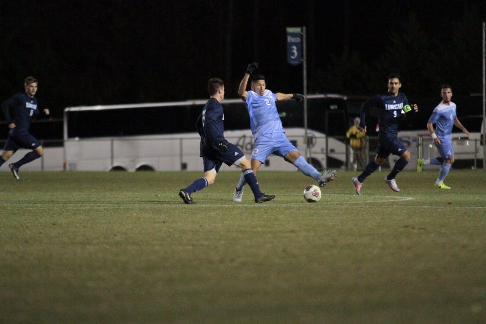 <p>Defender Mauricio Pineda (2) attempts to block a pass against UNC-Wilmington on Sunday night at WakeMed Soccer Park in Cary.</p>