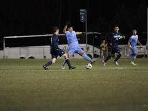 Defender Mauricio Pineda (2) attempts to block a pass against UNC-Wilmington on Sunday night at WakeMed Soccer Park in Cary.