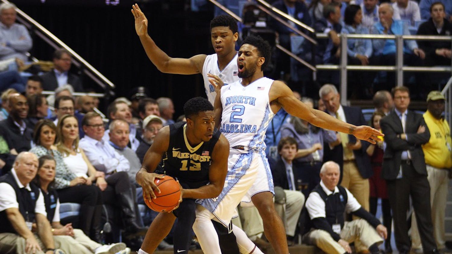 Freshman guard Bryant Crawford (13) is double-teamed by Joel Berry (2) and Isaiah Hicks (4) during Wednesday night’s game in Chapel Hill.