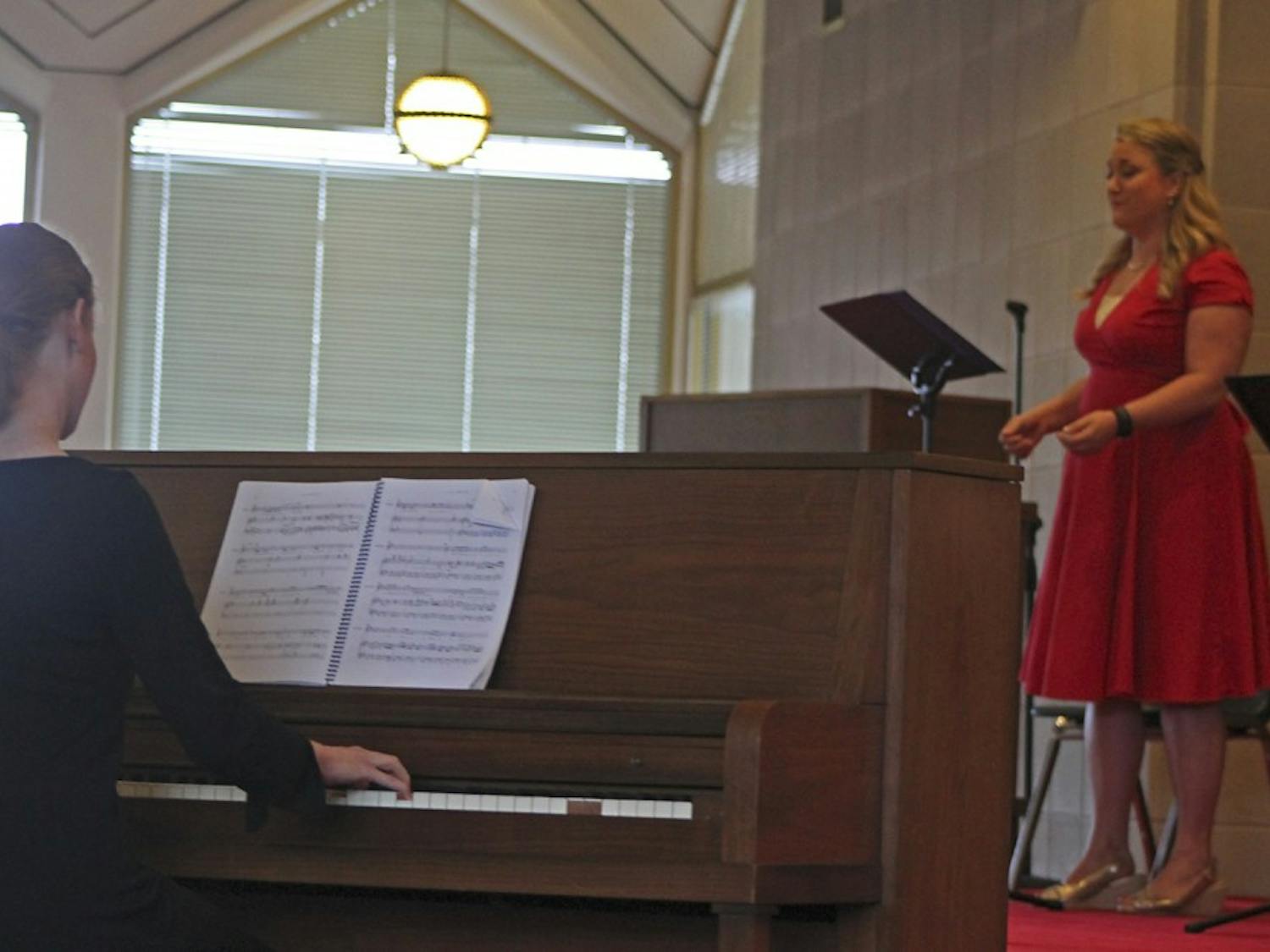 Julia Carey (left) plays piano for "The Body Politic" as Kristin Schwecke (right) performs the role of Constance.