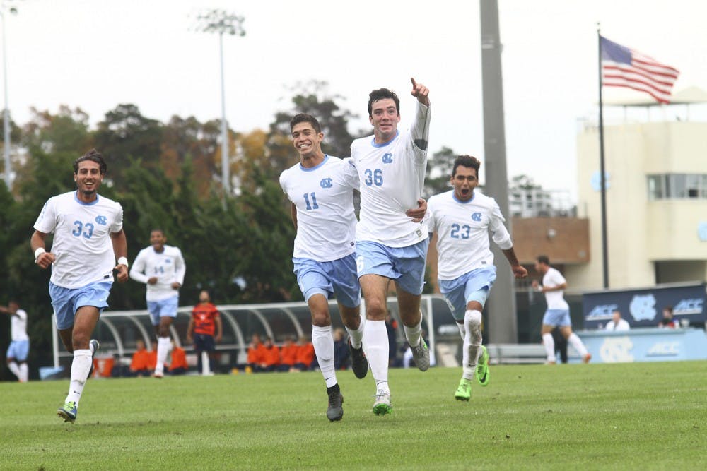 The Tar Heels celebrate after Tucker Hume (36) scored against Syracuse Sunday afternoon in the quarterfinals of the ACC tournament. 
