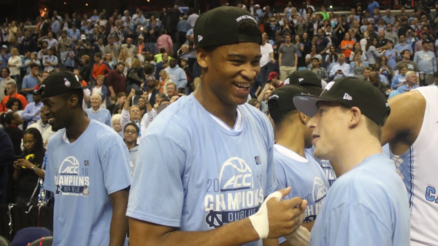 North Carolina forward Isaiah Hicks (left) greets teammate Stilman White (right) after the UNC men's basketball team defeated Virginia 61-57 in the ACC Championship on Saturday.