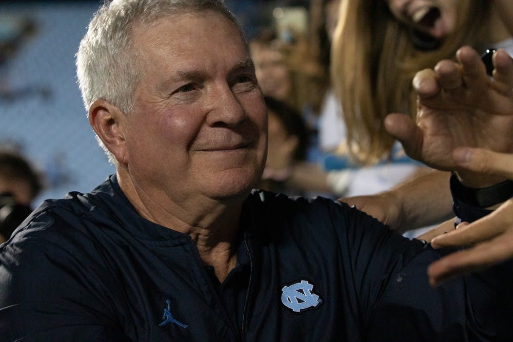 Head Coach Mack Brown celebrates with students and fans after UNC's win on Saturday, Oct. 26, 2019. UNC defeated Duke 20-17. UNC had not beat Duke since 2015.
