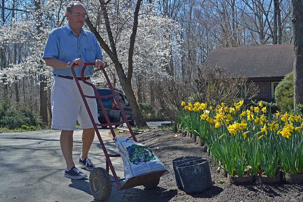Creighton Moeller, founder of Project Stackhouse, plants flowers outside of his Chapel Hill home to benefit the therapy dog program at UNC Children's Hospital.