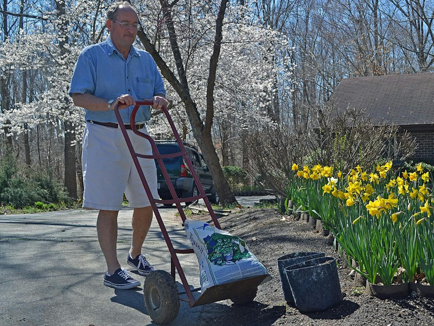 Creighton Moeller, founder of Project Stackhouse, plants flowers outside of his Chapel Hill home to benefit the therapy dog program at UNC Children's Hospital.