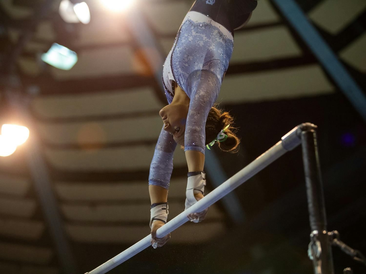 UNC sophomore Julia Knower spins on the bar during UNC's competition against George Washington on Saturday, Jan. 28, 2023 at Carmichael Arena. UNC won 196.325-195.350.