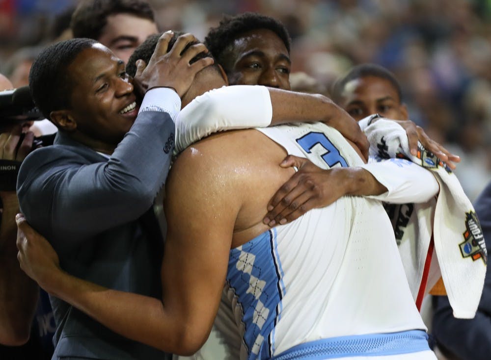 North Carolina forward Kennedy Meeks (3) is embraced by guards Kenny Williams and Brandon Robinson after recording 25 points and 14 rebounds against Oregon in the teams' Final Four matchup on Saturday in Phoenix.