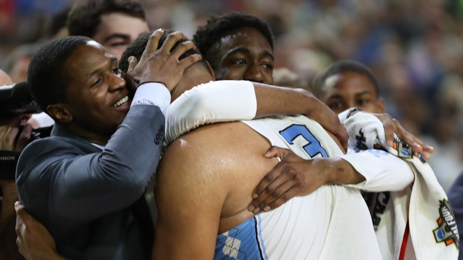 North Carolina forward Kennedy Meeks (3) is embraced by guards Kenny Williams and Brandon Robinson after recording 25 points and 14 rebounds against Oregon in the teams' Final Four matchup on Saturday in Phoenix.