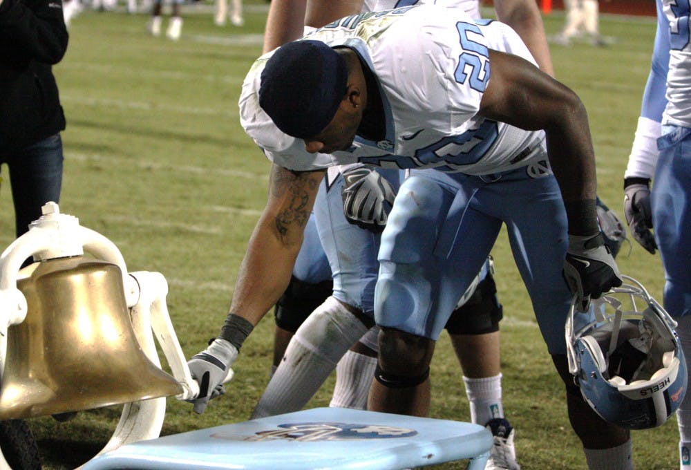 Senior tailback Shaun Draughn rings the Victory Bell following UNC’s 24-19 win against rival Duke. The senior class never suffered a loss to the Blue Devils in four years.