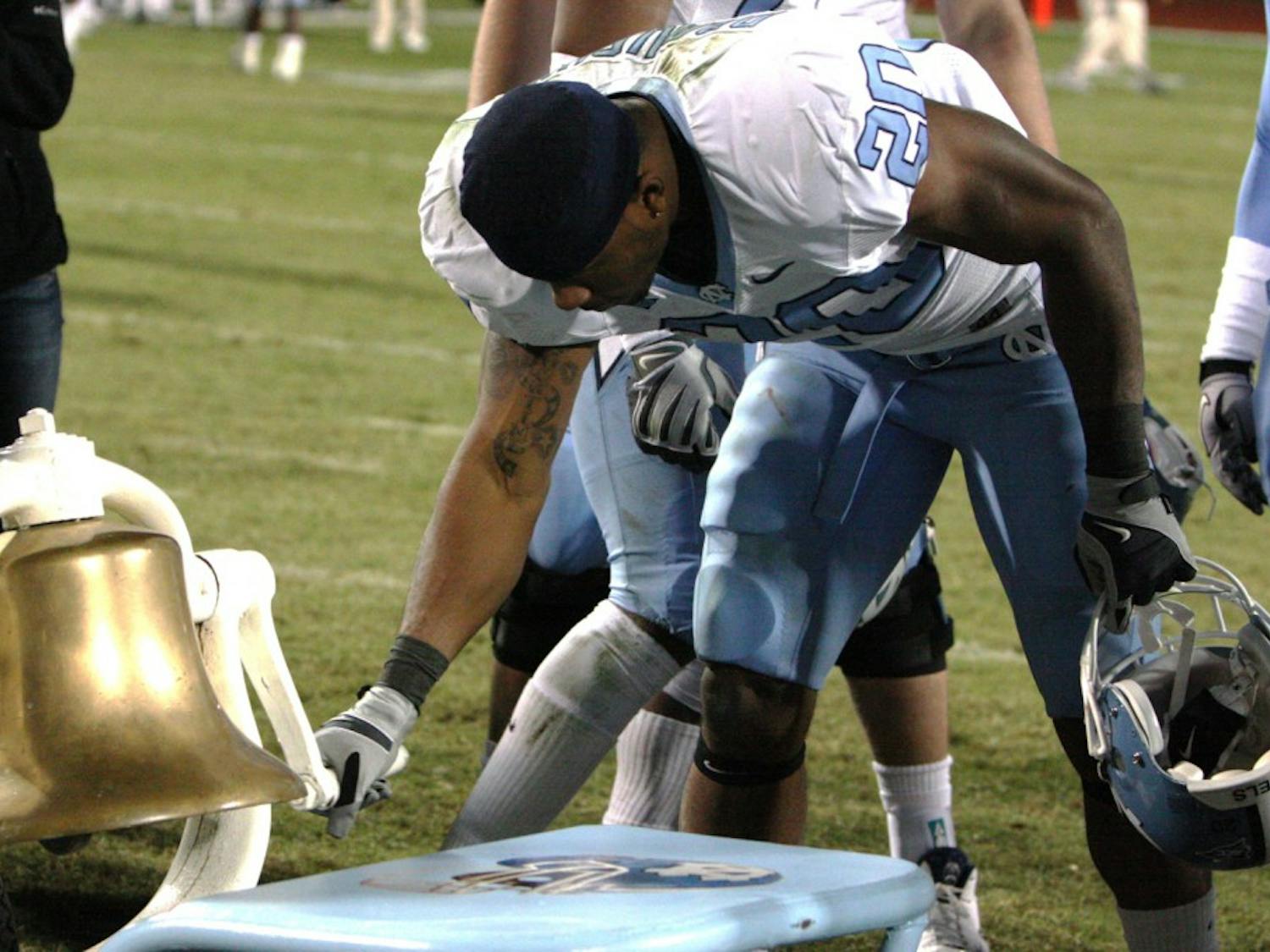 Senior tailback Shaun Draughn rings the Victory Bell following UNC’s 24-19 win against rival Duke. The senior class never suffered a loss to the Blue Devils in four years.