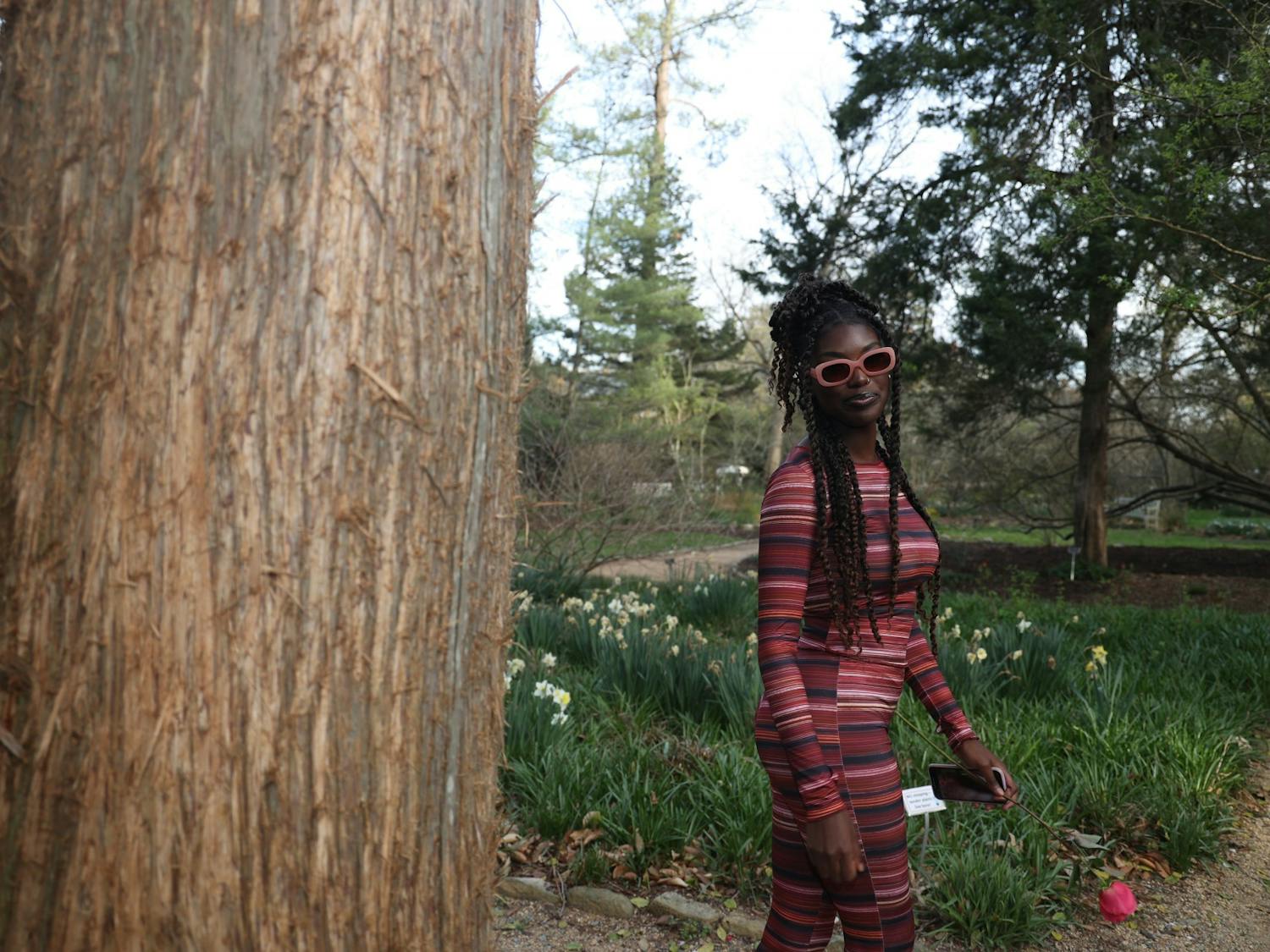 UNC sophomore Jaziah Planter shows off her pink sunglasses and outfit in Coker Arboretum on Friday, March 20, 2023.