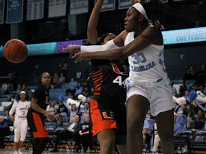 UNC junior center Janelle Bailey (30) passes the ball to a teammate during the Tar Heels' 78-58 victory over the Miami Hurricanes on Thursday, Jan. 16, 2020 at Carmichael Arena. Bailey finished the game with 28 points and 15 rebounds.