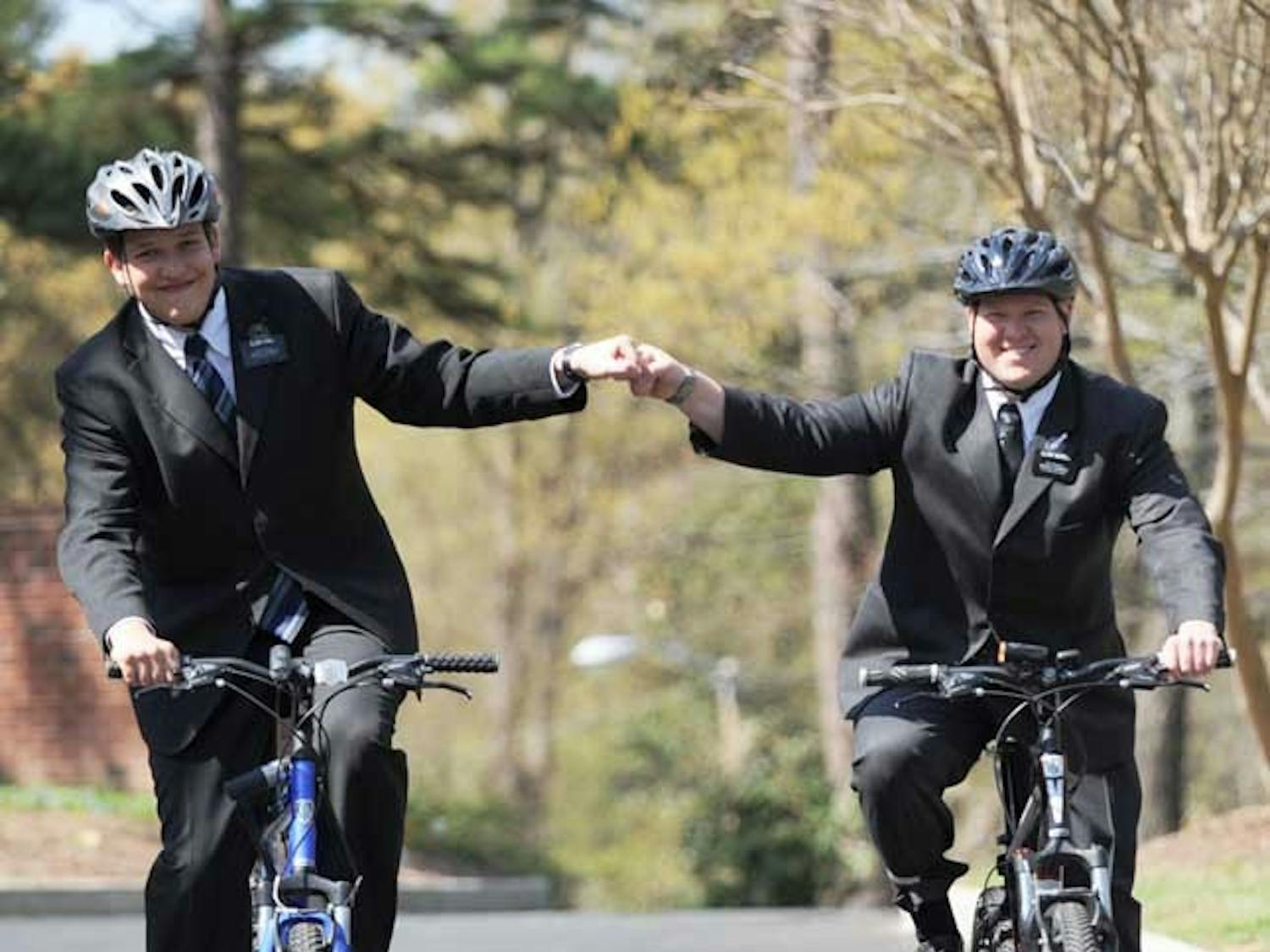 Having only been provided bicycles for transportation, Elder Call, on the left, and Elder Merrill, on the right, are required to stay within sight and sound of each other at all times. 