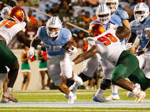 First-year running back Omarion Hampton (28) carries the ball down the field during UNC's opening game against Florida A&amp;M at Kenan Stadium on Aug. 27, 2022.