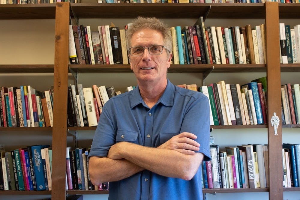 History professor Jay Smith, co-author of "Cheated," poses in front of his collection of books on Monday, Oct. 29, 2019. Smith recently spoke with C-SPAN and the interview will air in January 2020.