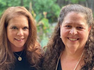 Randi Emerman (left) and Carol Marshall (right), co-founders of Film Fest 919, smile together for a portrait. Photo courtesy of Carol Marshall.