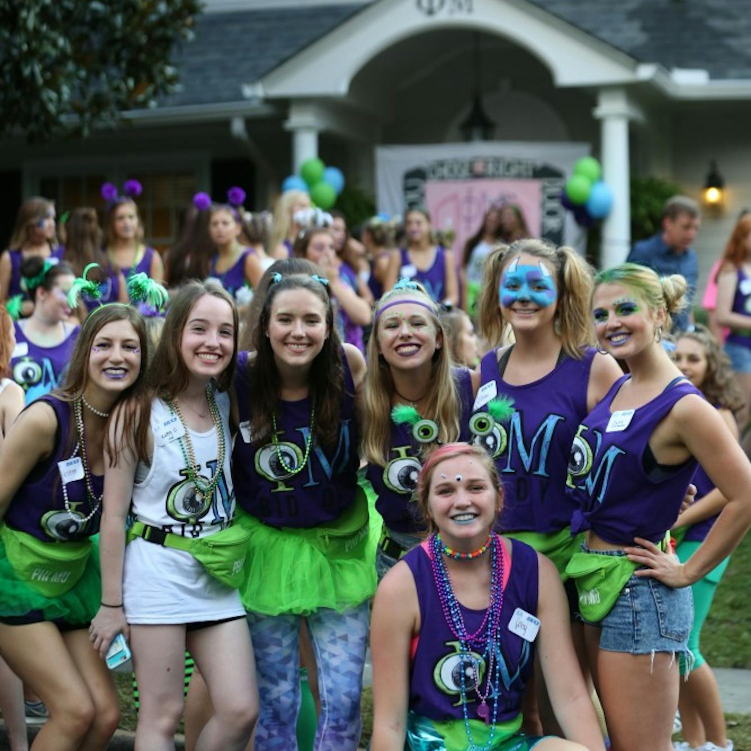 Members of Phi Mu stand in front of their sorority house.