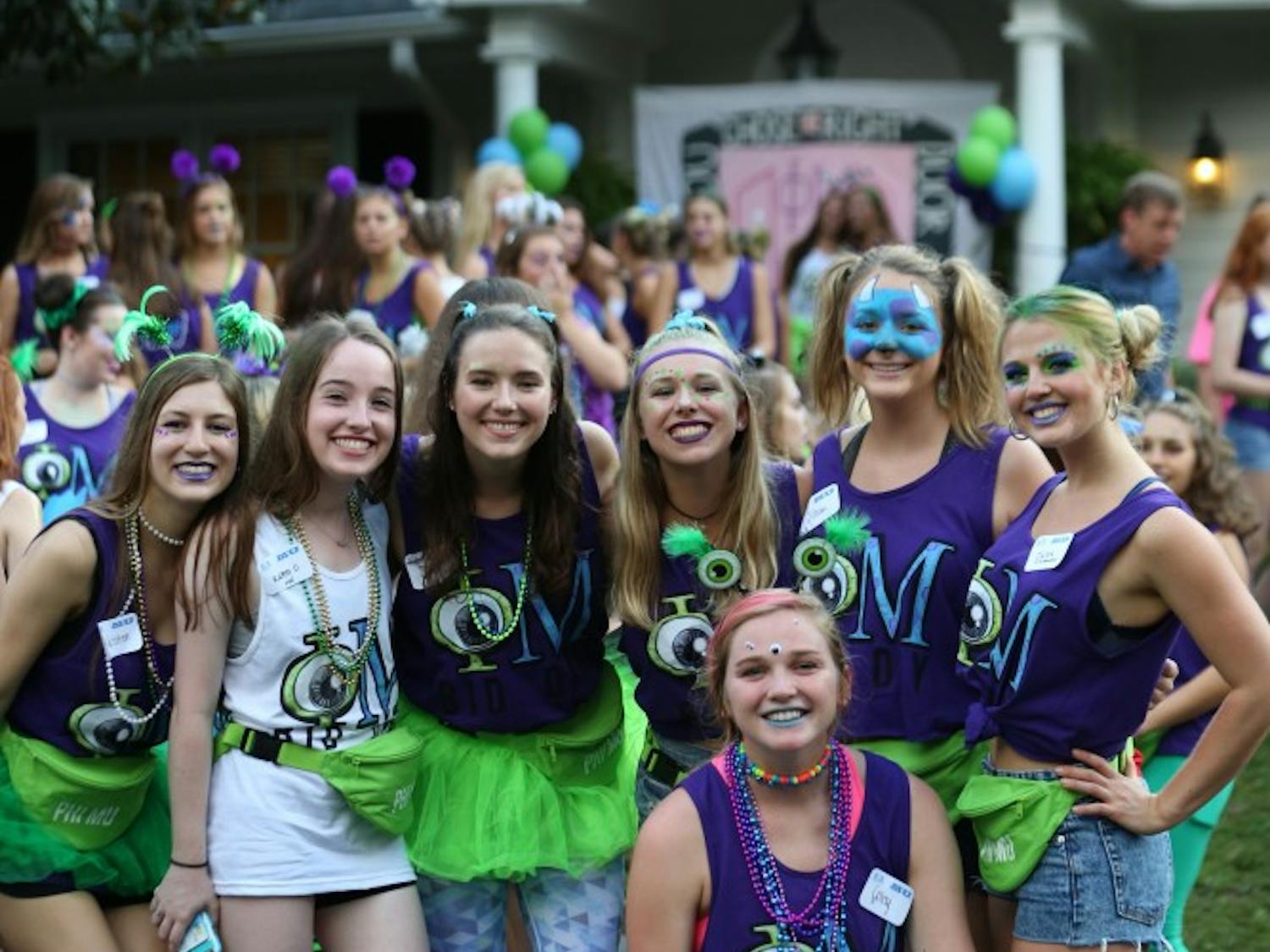 Members of Phi Mu stand in front of their sorority house.