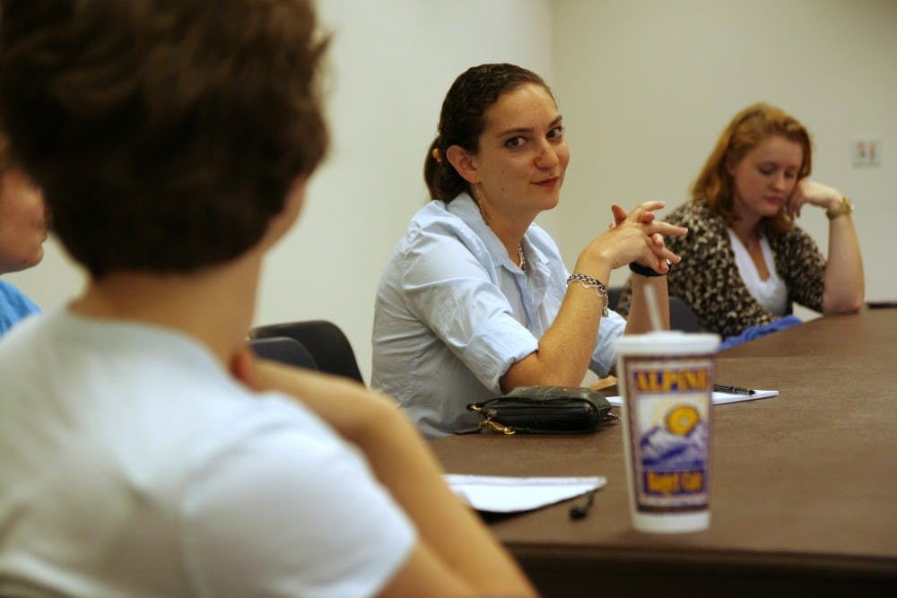 Ph.D neurobiology student Rebecca Balter (center) listens to a peer speak at the LGBTQ Center’s roundtable discussion Wednesday.