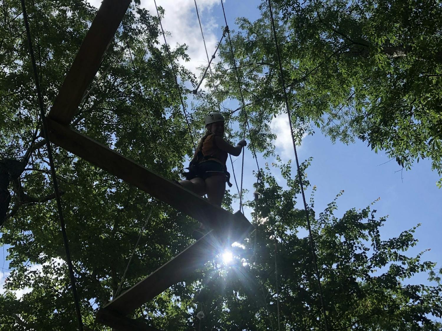 Audience Engagement Editor Elise Trexler climbs a rope course at the Adventure Center of Asheville in 2021. Photo Courtesy of Elise Trexler.