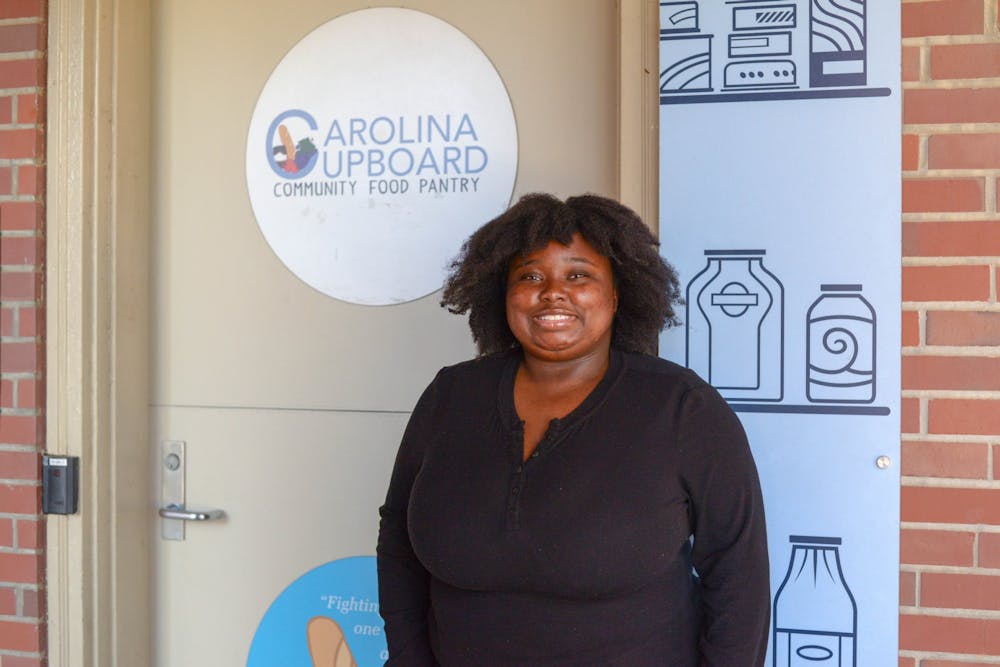 Kayla Brown is the vice president of the Carolina Cupboard. She stands outside of the organization's community food pantry on Tuesday, Nov. 23, 2021. 