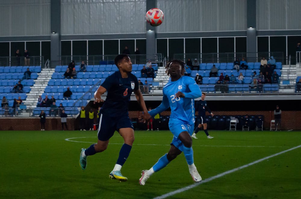 UNC junior forward Ernest Bawa (20) receives the ball during the UNC men's soccer 2-2 tie against UVA on Friday, Oct. 28, 2022 at Dorrance Field.
