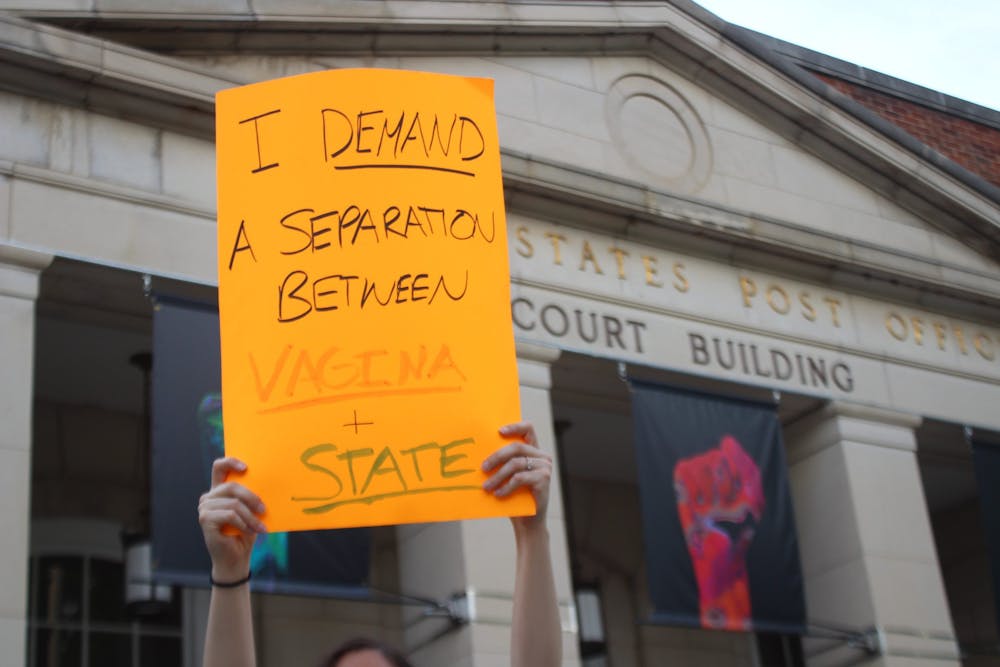<p>People protest the leaked, proposed overturn of Supreme Court case Roe v. Wade on May 3, 2022, &nbsp;in Chapel Hill, NC.&nbsp;</p>