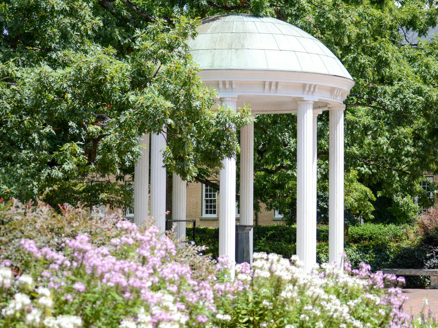 The Old Well, complimented by late summer flora, stands tall on Aug. 7, 2022.&nbsp;