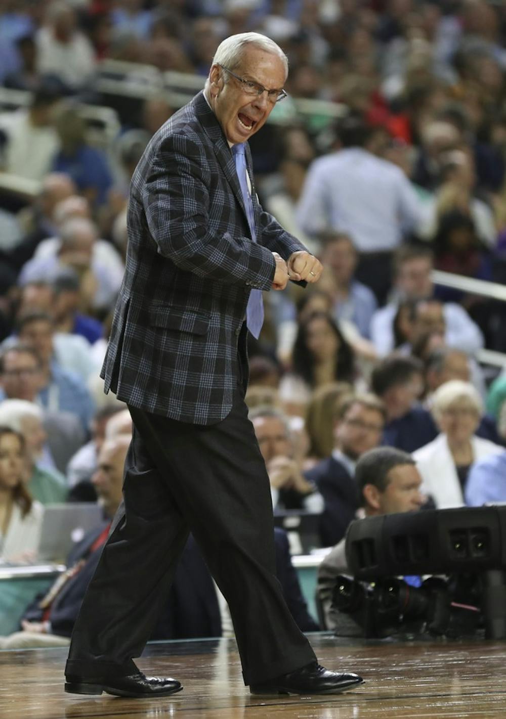 <p>North Carolina men's basketball coach Roy Williams shouts out defensive instructions to the team during the national championship game.</p>